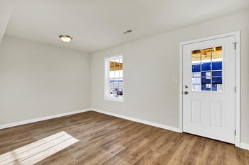 basement with hardwood floors and door leading to walk-out basement - Photo Gallery 10