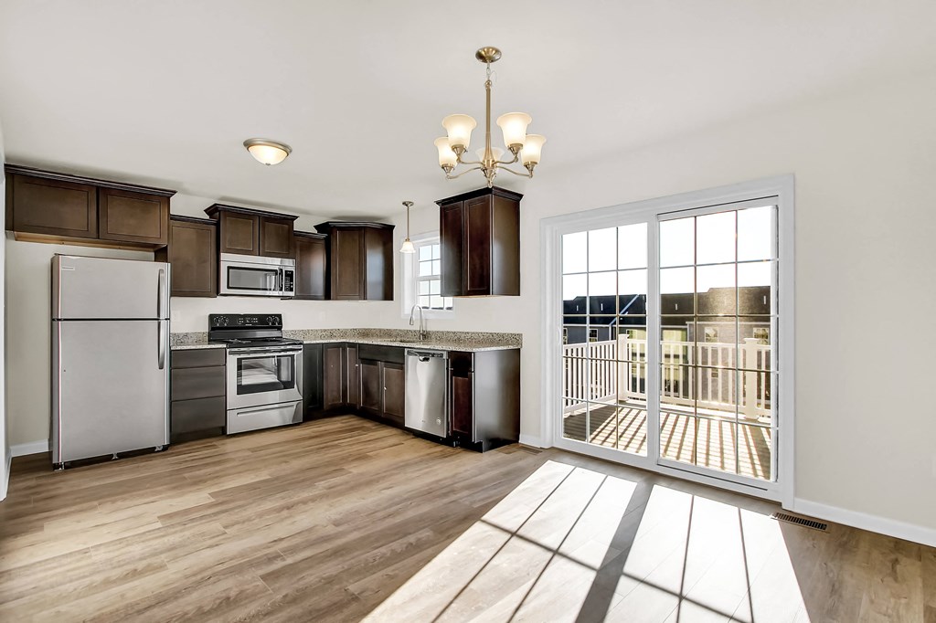 mocha cabinets with granite hardwood floors kitchen and dining looking into half bath and living room
