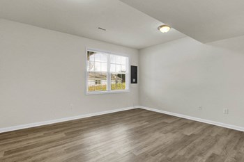 basement with hardwood floors and door leading to walk-out basement - Photo Gallery 17