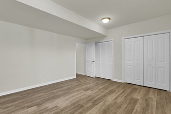 basement with hardwood floors and door leading to walk-out basement - Photo Gallery 18