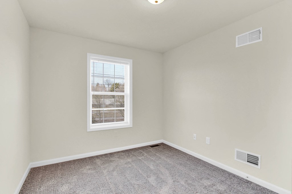 bedroom with grey carpet natural light  at Franklin Square Apartments/Townhomes, New Freedom, Pennsylvania