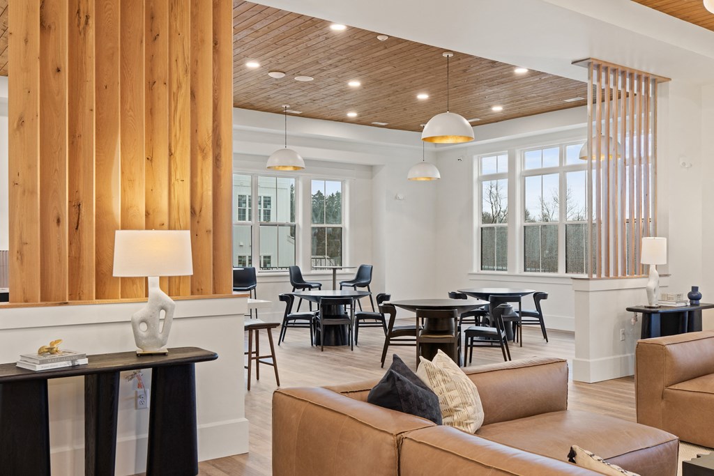 Living room with couches and chairs and a dining room with tables at Hadley Place Apartments, Pennsylvania, 17025