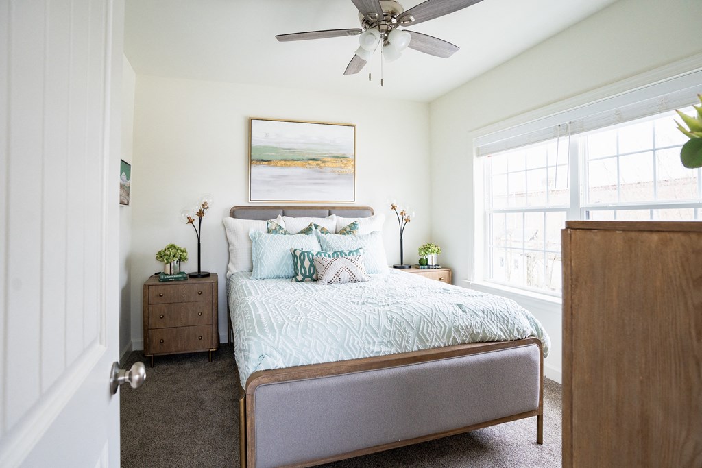 a bedroom with a bed and a ceiling fan  at Franklin Square Apartments/Townhomes, New Freedom, PA