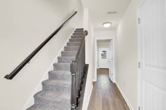 stairwell with grey carpet hardwood floors hallway leading to den  at Franklin Square Apartments/Townhomes, Pennsylvania