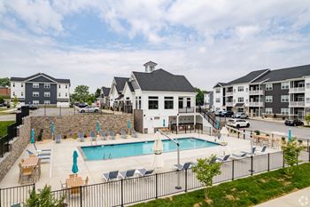 gated pool and sundeck with umbrellas at Wynfield apartments and townhomes in York, PA