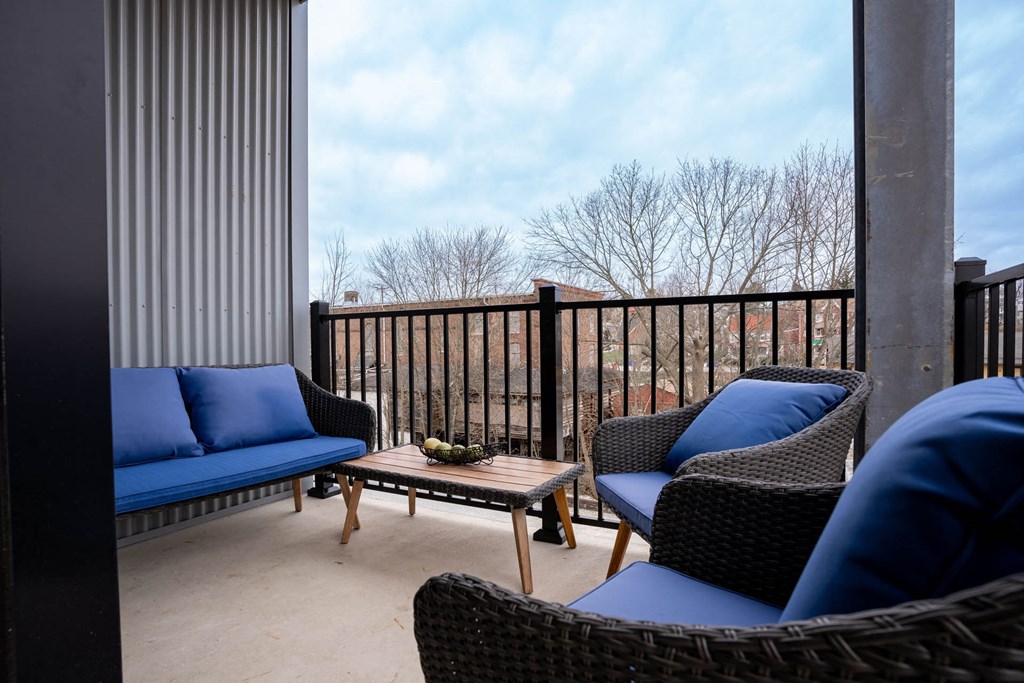 Balcony with couches and a coffee table at Holly Oaks, Maryland.
