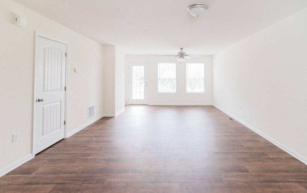 living room with hardwood floors natural light