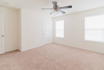 bedroom with grey carpet and ceiling fan natural light - Photo Gallery 5