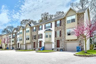 brick and beige siding beige garage doors