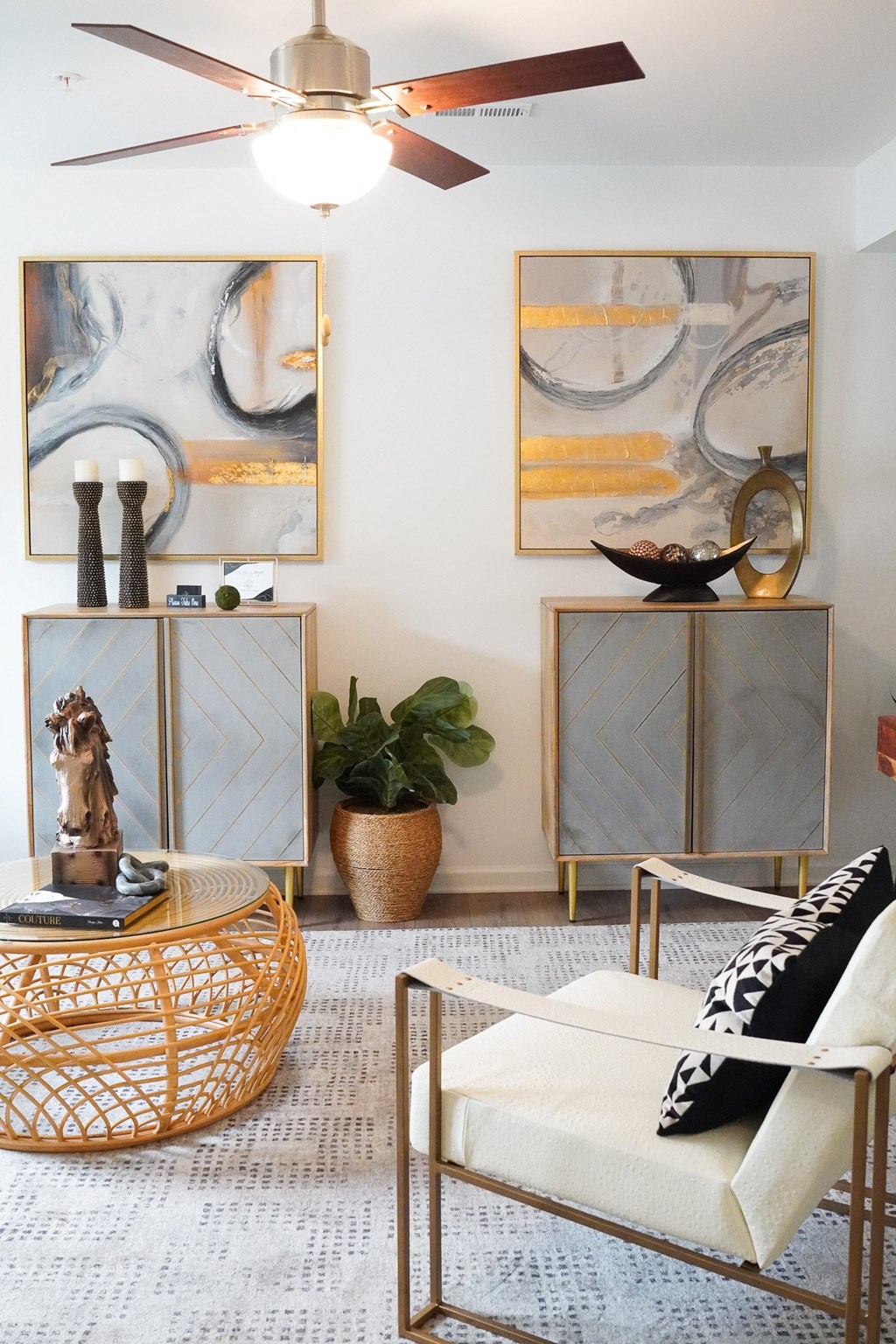 a living room with a couch and a table and a ceiling fan