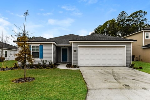 a home with a white garage door and a driveway