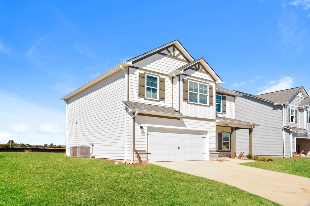 a white house with a garage and a blue sky