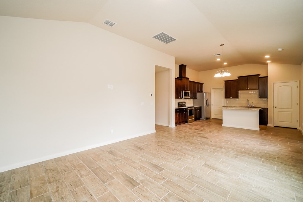an empty kitchen and living room with tile flooring