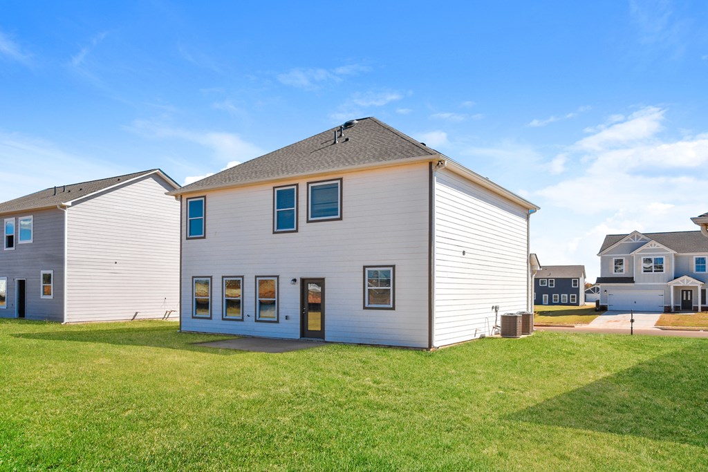 a white house with a yard in front of it