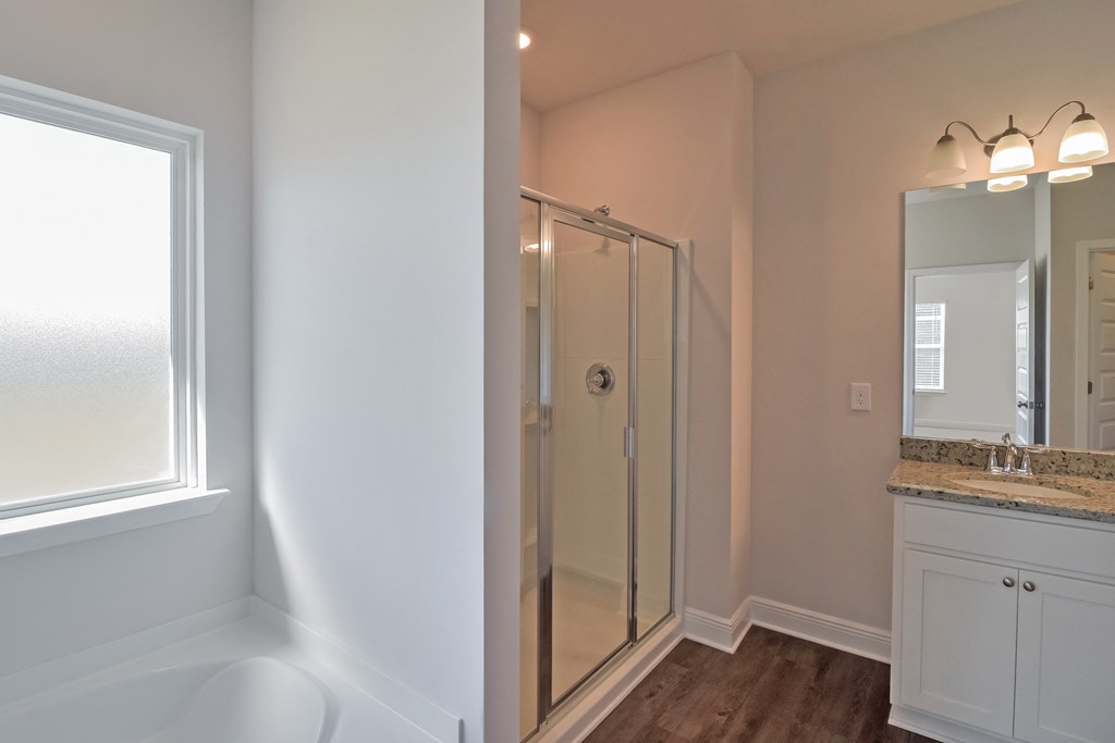 a bathroom with a shower and a sink and a mirror