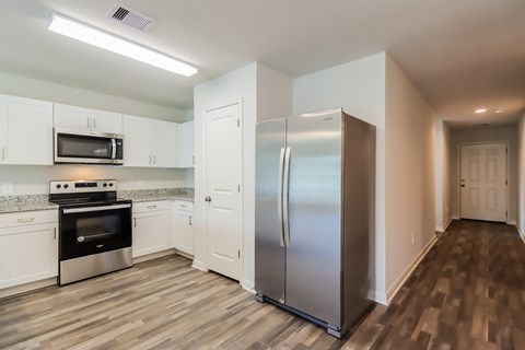 a kitchen with stainless steel appliances and white cabinets