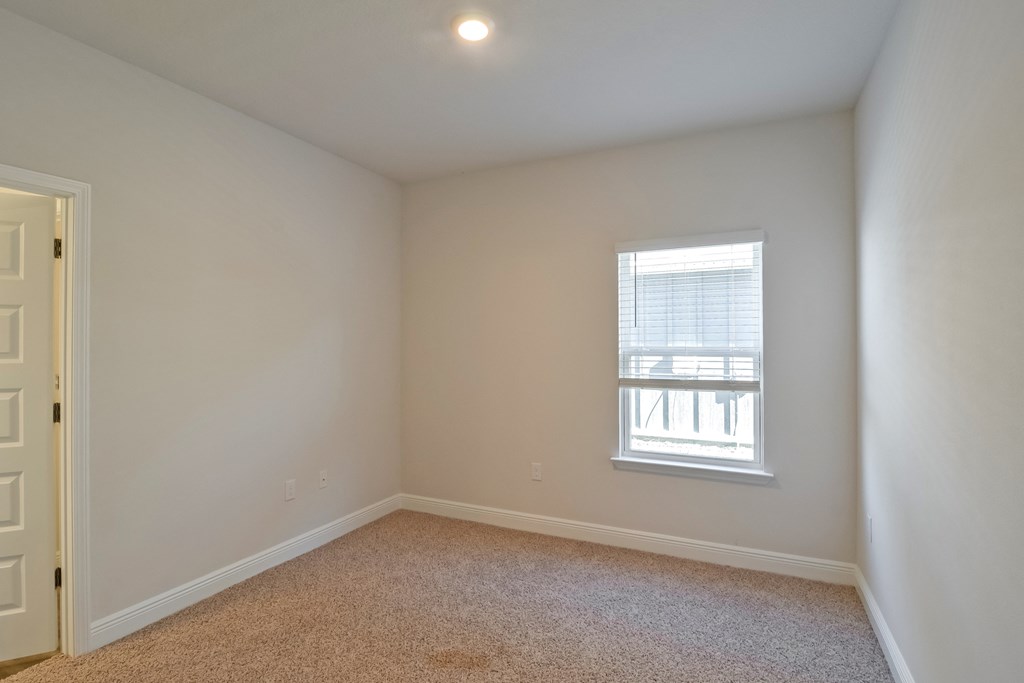 an empty room with a window and a door