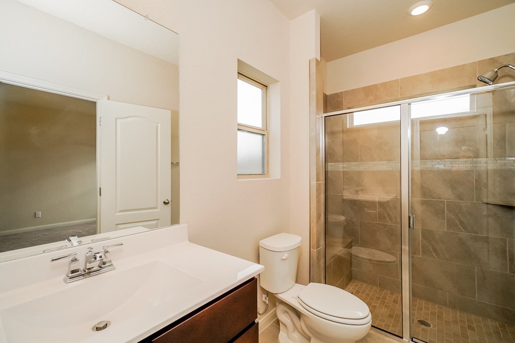 a bathroom with a toilet sink and shower