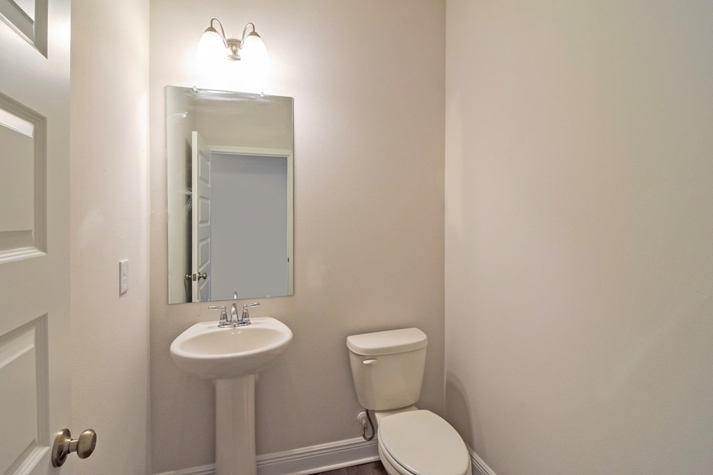 a bathroom with a sink and a toilet and a mirror