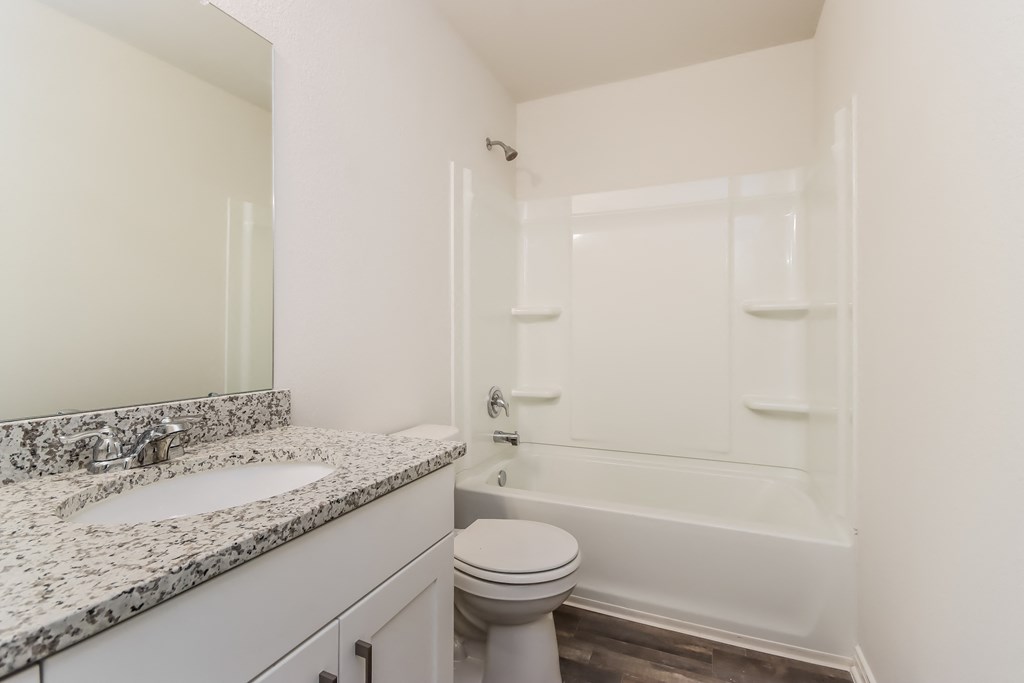 a bathroom with a sink toilet and a bath tub