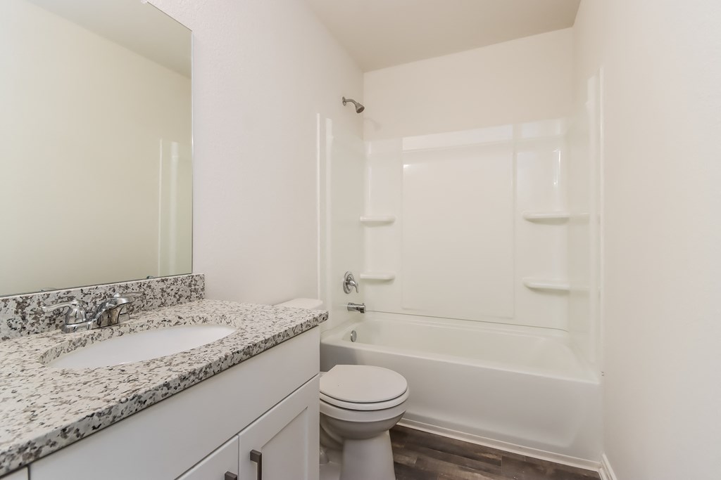 a bathroom with a sink toilet and a bath tub