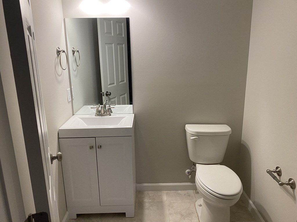a small bathroom with a toilet sink and mirror