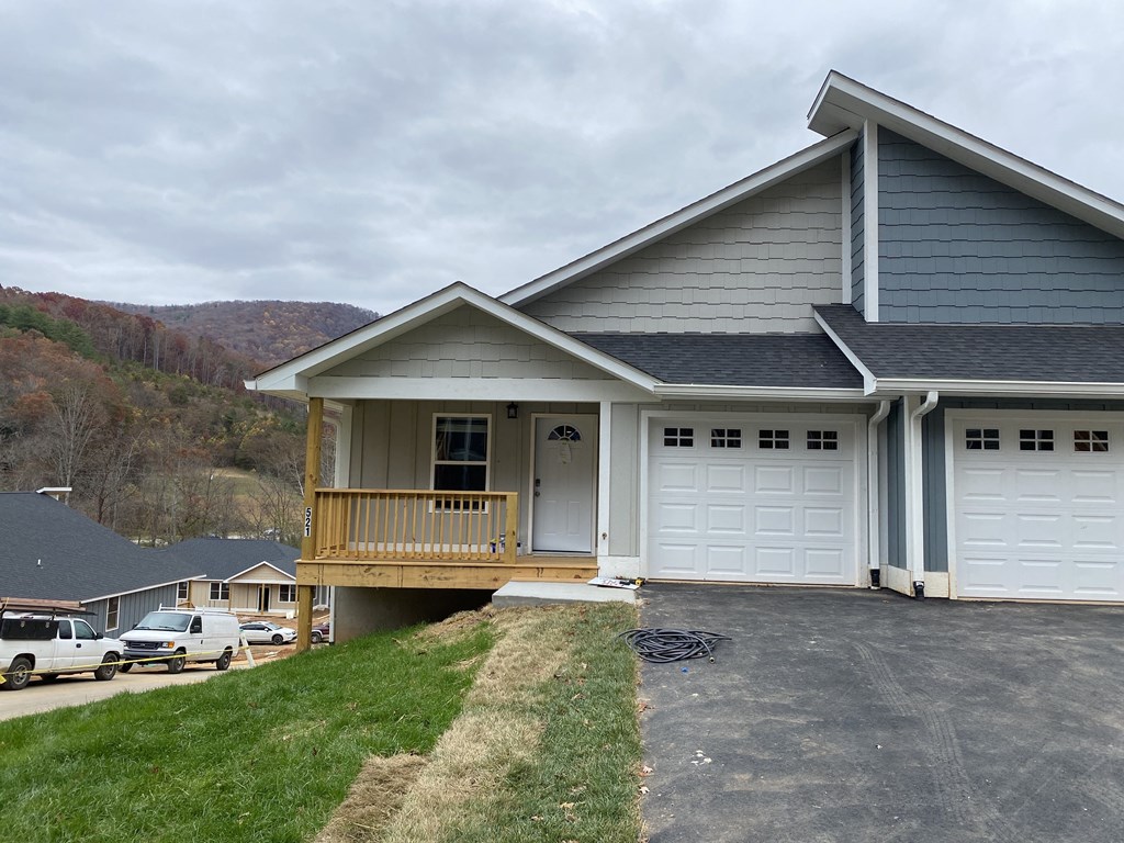 a house with a porch and a white garage door