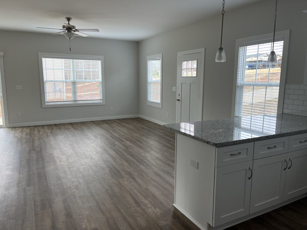a kitchen with white cabinets and a counter top
