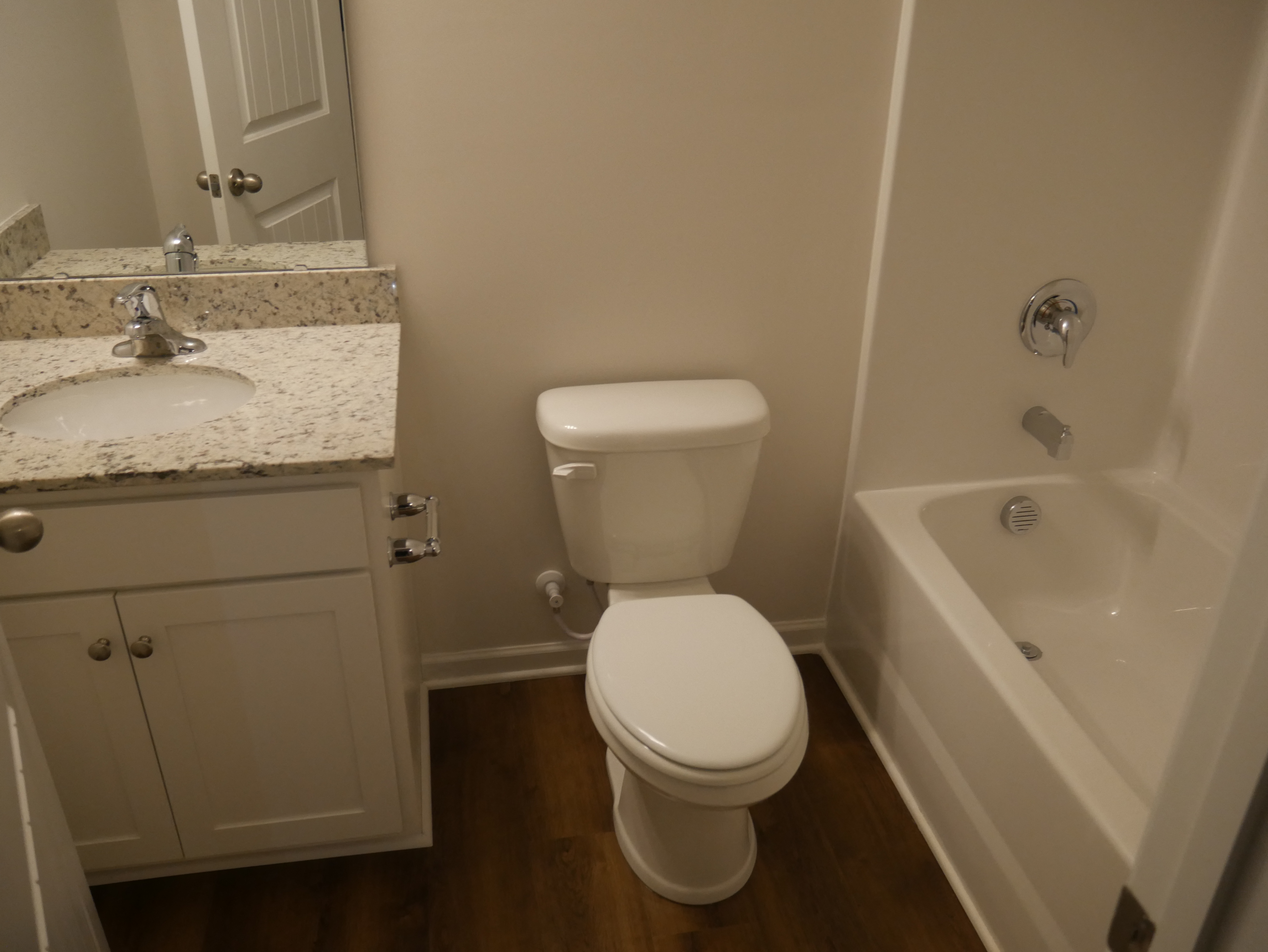 a bathroom with a toilet and a sink and a bath tub