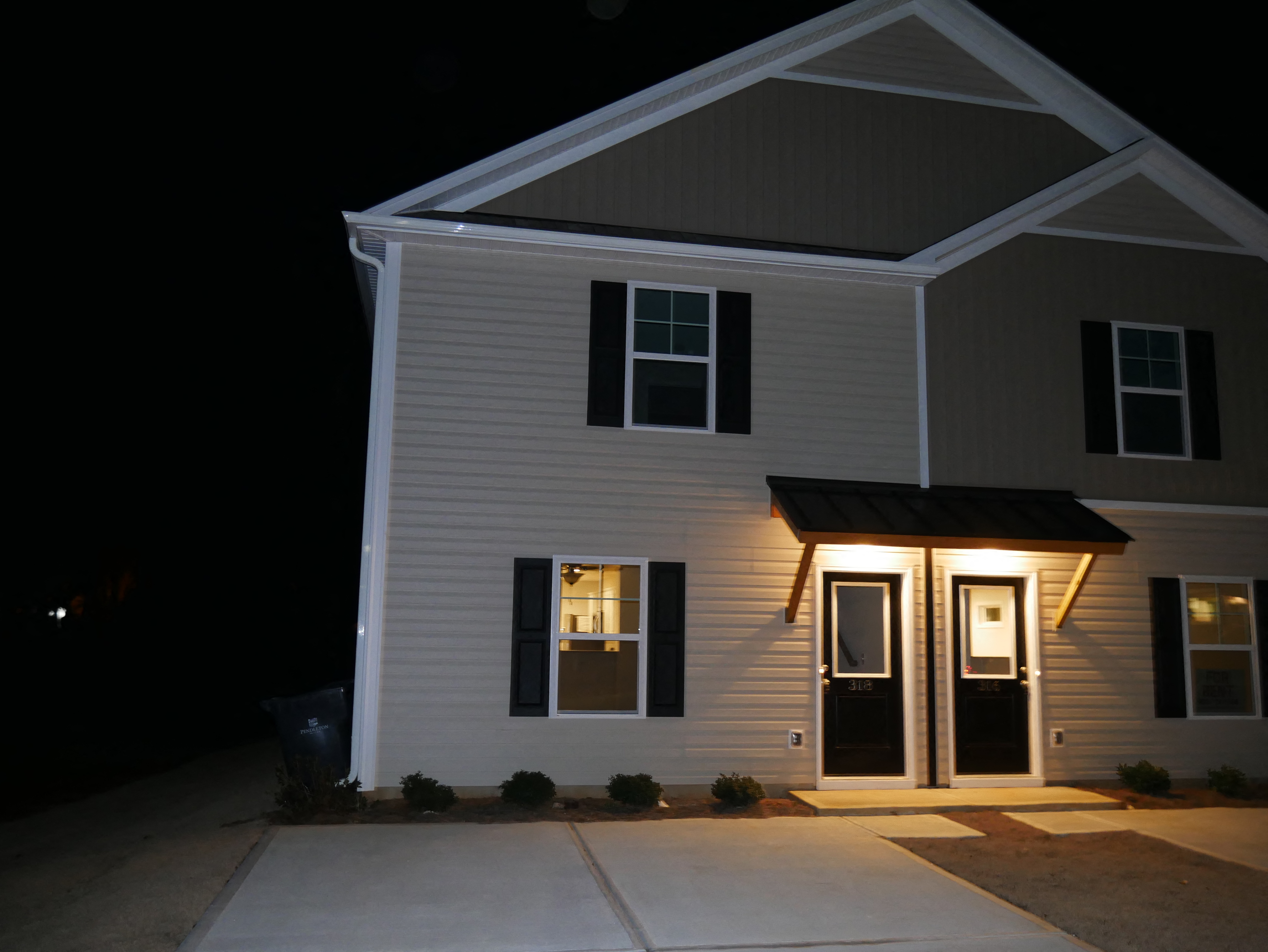 a white house at night with its lights on