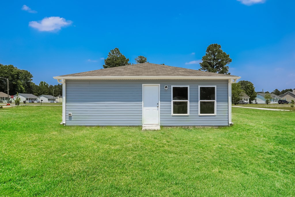 a small house in the middle of a field