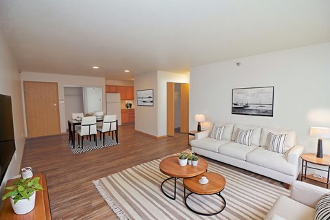 A living room with a white couch and a coffee table.