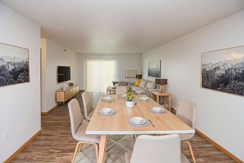 A dining room with a long table set for six people.