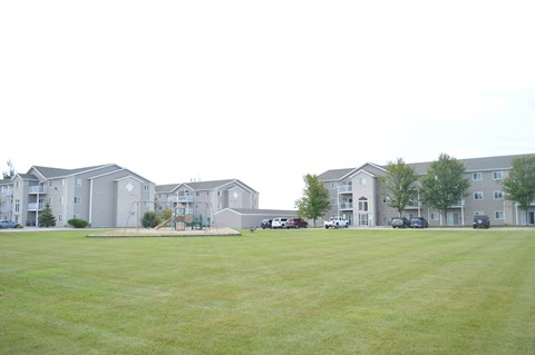 Apartment complex with a green lawn in front.
