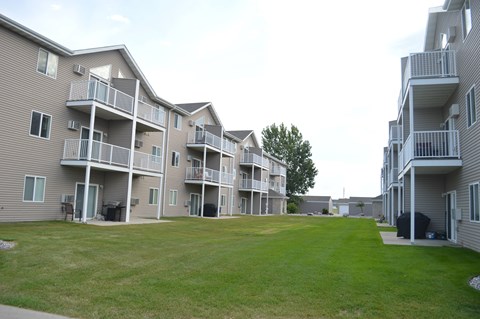 Apartment complex with a green lawn in front.