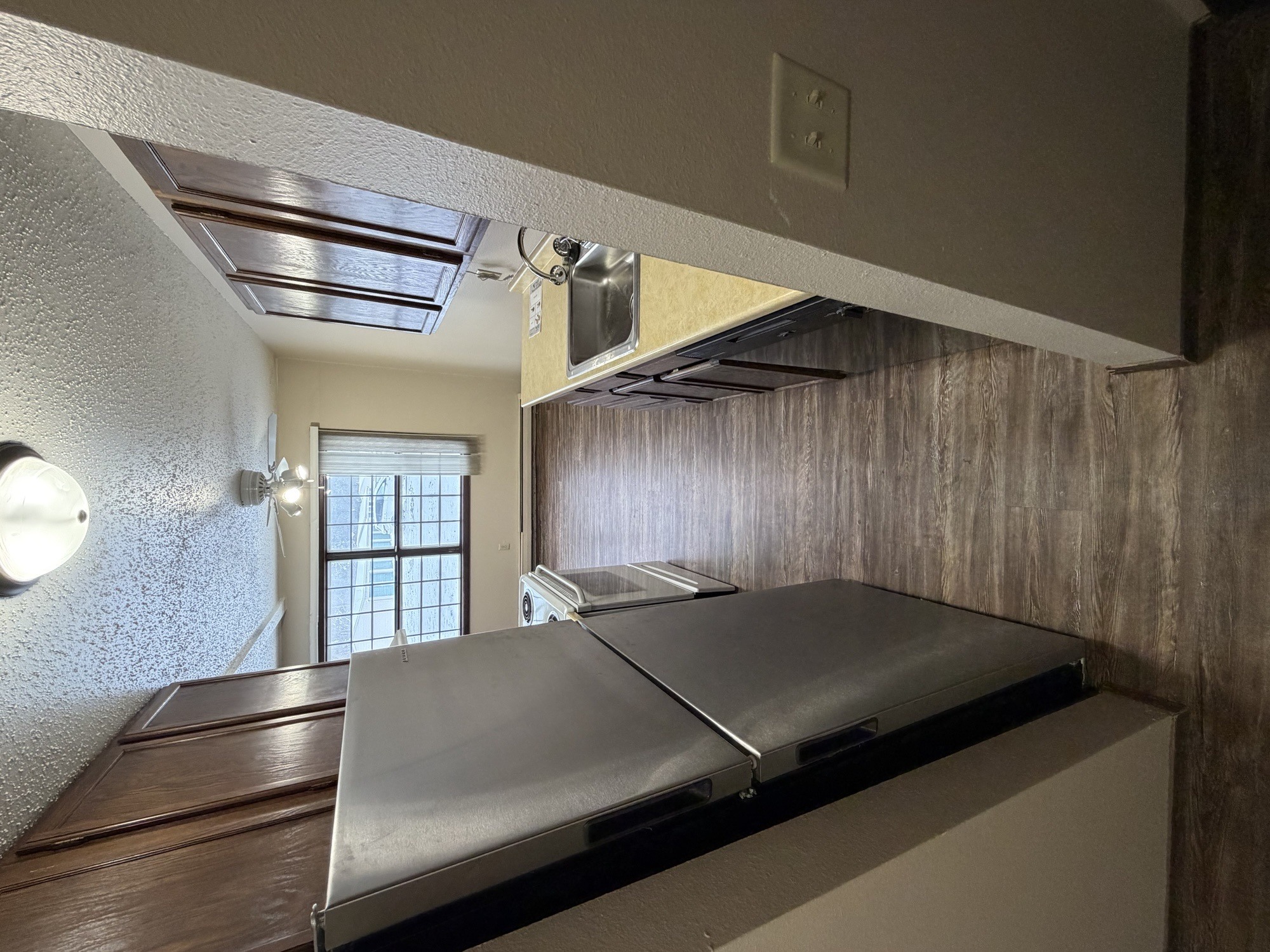 A stainless steel countertop in a room with a window.