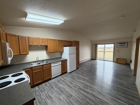 A kitchen with wooden cabinets and a white refrigerator.