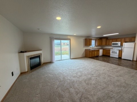 A living room with a television and sliding glass doors.
