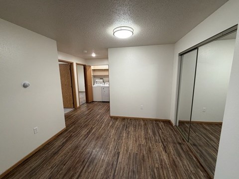 A room with wooden flooring and a ceiling light.