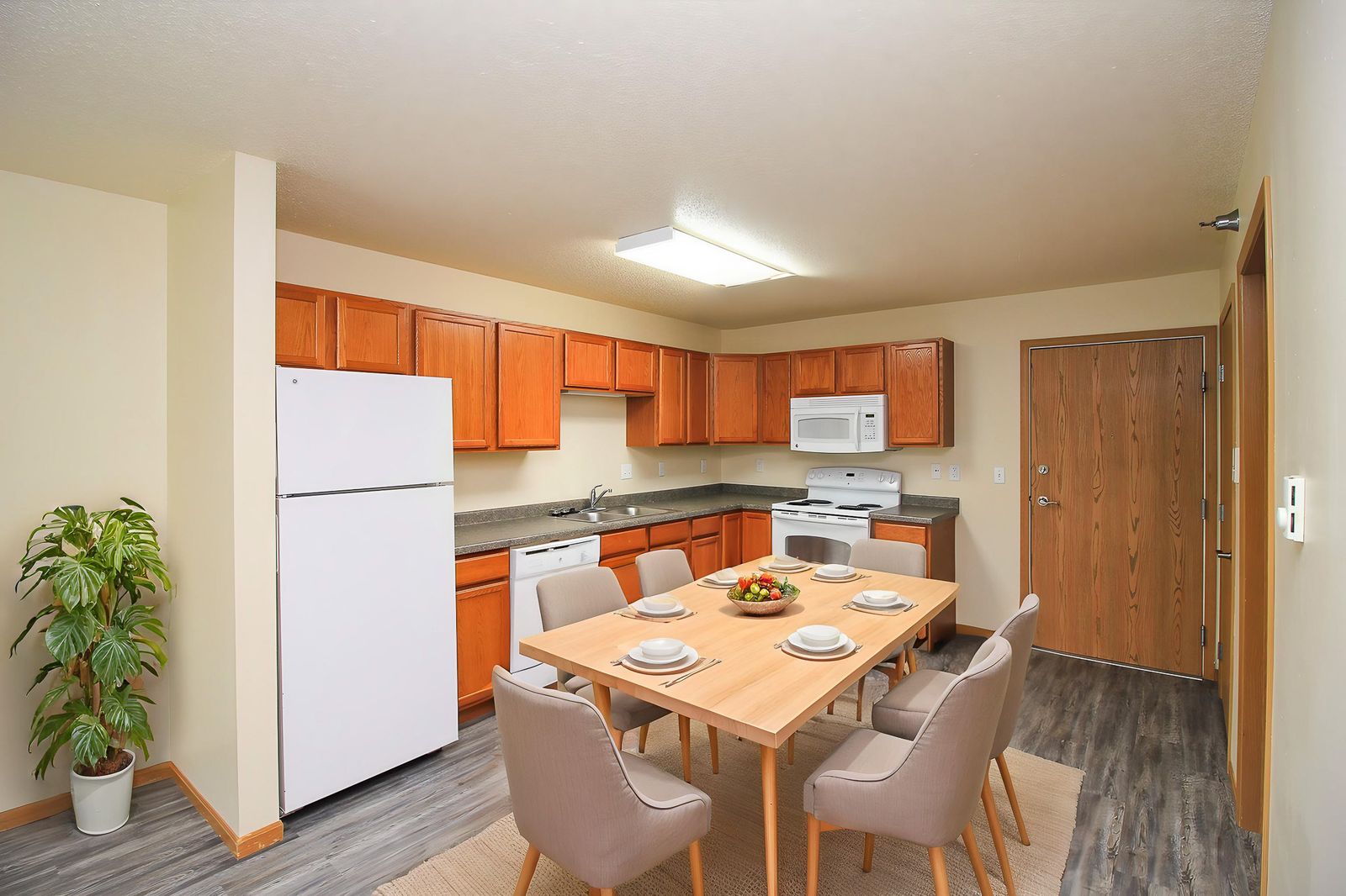 A kitchen with a table set for four.