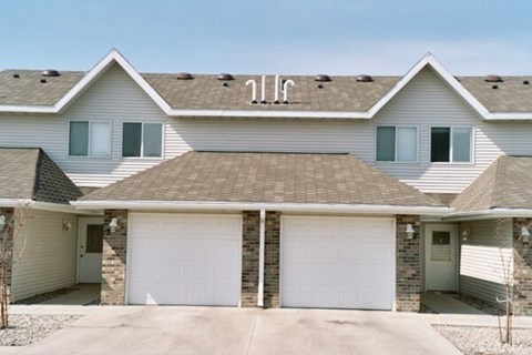 A two-story house with a garage on the first floor.