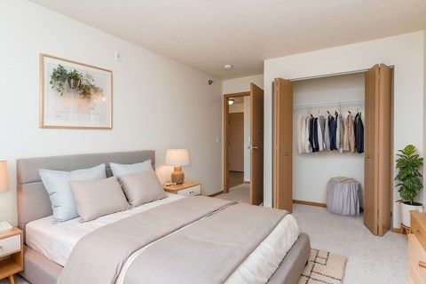 A bedroom with a large bed and a wardrobe.