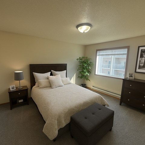 A bedroom with a large bed and a window.