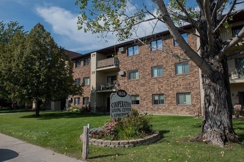 A brick building with a sign that says "Cooperative Living Center".