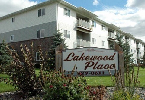 A sign for Lakewood Place in front of a building.