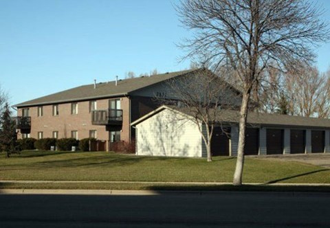 A large building with a white garage door is in the background.