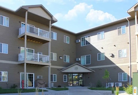 A large apartment complex with a central courtyard and multiple balconies.