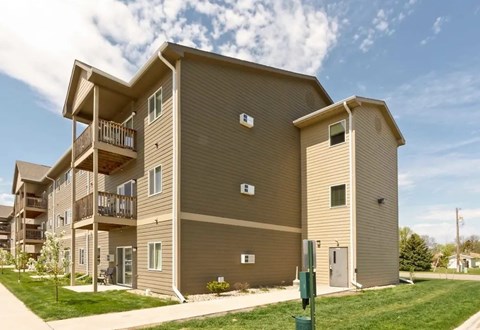 A large apartment building with multiple balconies and doors.