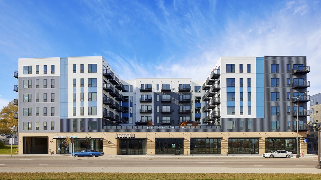 a rendering of an apartment building on a city street