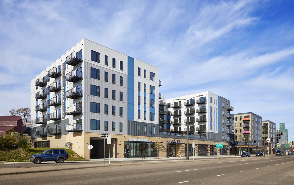 a large blue and white building on a city street